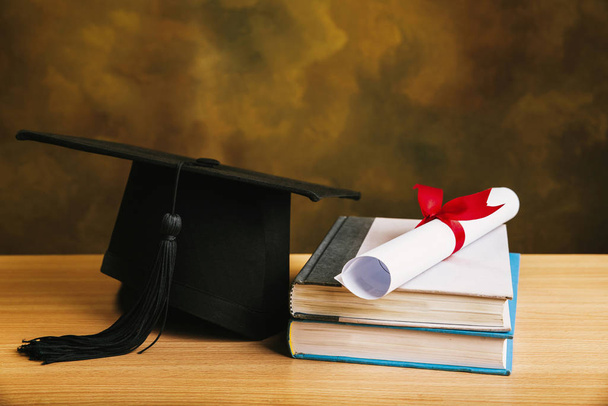Graduation concept.graduation cap, hat with degree paper on wood - Zdjęcie, obraz
