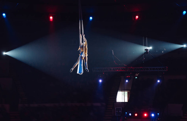 Girls aerial acrobatics in the Circus ring. - Fotó, kép