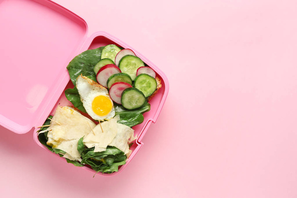 School lunch box with tasty food on color background - Photo, Image