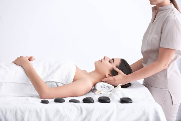 Beautiful young woman receiving massage in spa salon - Fotografie, Obrázek