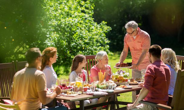 happy family having dinner or summer garden party - Φωτογραφία, εικόνα