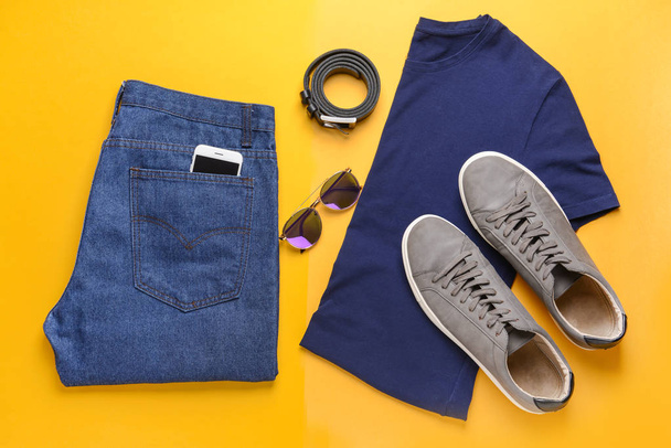 Stylish male look with jeans clothes on color background - Photo, Image