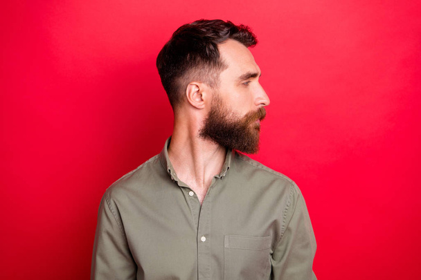 Photo of suspicious man showing results of his barber work while isolated with red background - Photo, Image