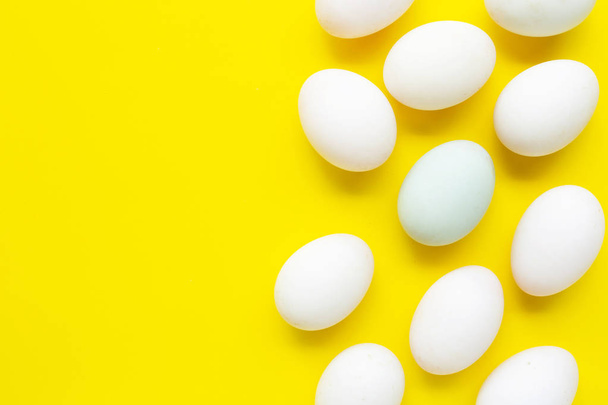 White eggs on yellow background.  - Fotoğraf, Görsel