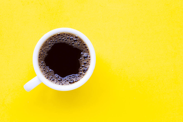 Hot black coffee on  yellow background.  - Foto, afbeelding
