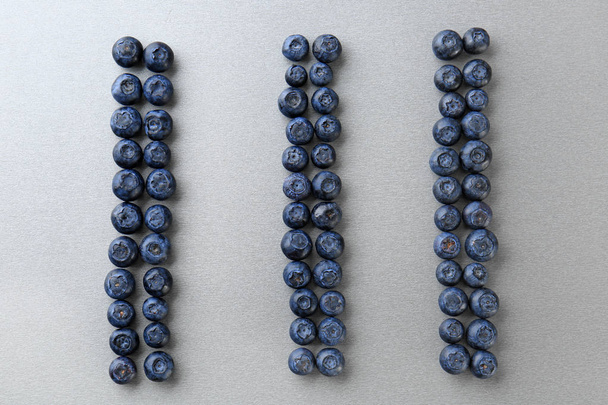 Ripe blueberry on grey background - Valokuva, kuva