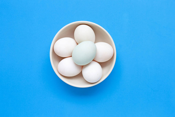 White eggs on blue background.  - Foto, afbeelding