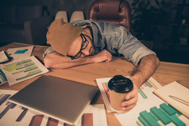 Photo of working at dark time boss guy fell asleep hot coffee beverage not helping wear casual outfit lying on table - Foto, Imagem