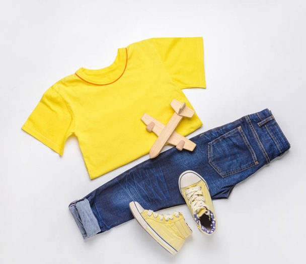 Stylish child look with jeans clothes on white background - Photo, Image