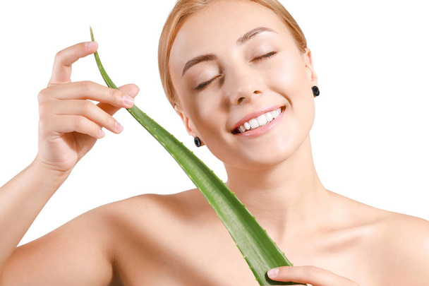 Beautiful young woman with aloe vera on white background - Фото, изображение