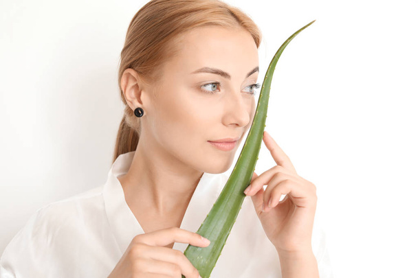 Beautiful young woman with aloe vera on white background - Fotografie, Obrázek