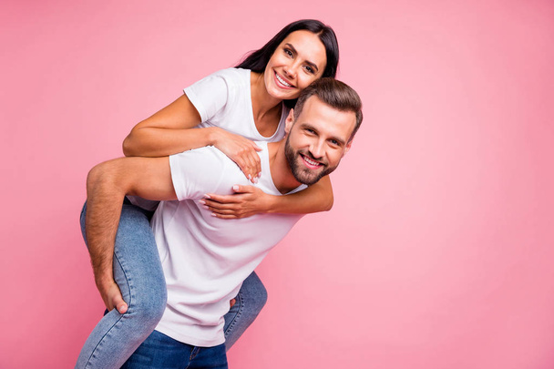 Photo of glad cheerful rejoicing couple with girlfriend embracing her chosen one from back while isolated with pastel background - Fotografie, Obrázek