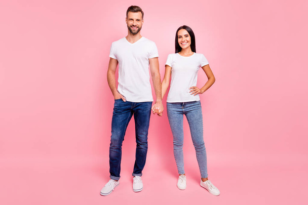 Full length body size photo of glad funky couple standing hand in hand while isolated with pastel background - Zdjęcie, obraz