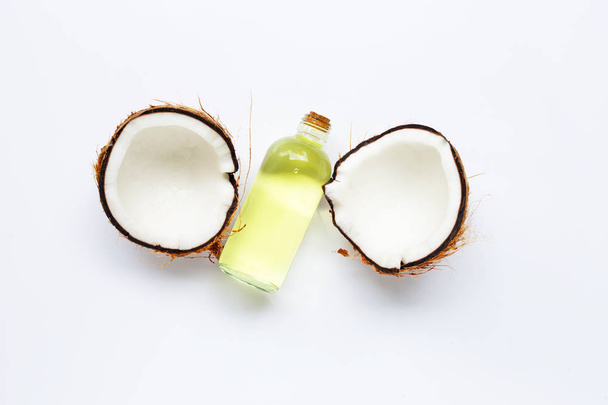 Coconut oil with coconuts on white - Photo, Image