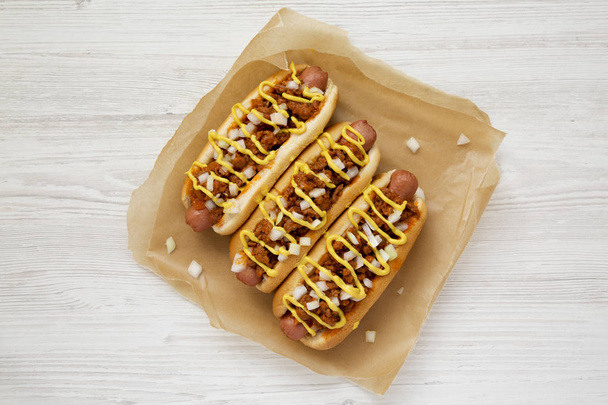 Homemade Detroit style chili dog on parchment, view from above.  - Photo, Image