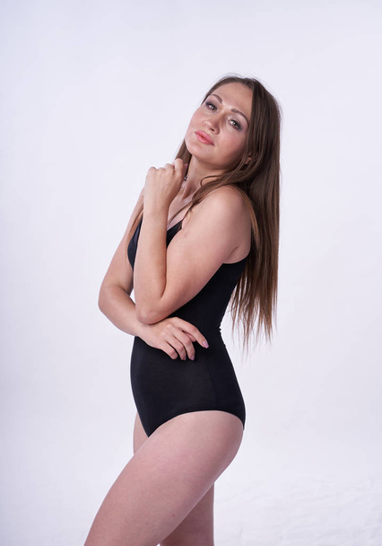 Beautiful girl in swimsuit posing against grey white background. Well-groomed skin.  - Fotografie, Obrázek