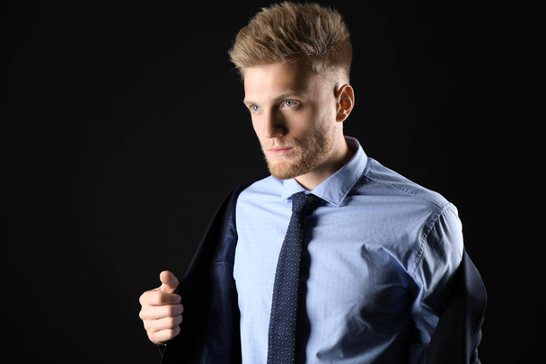 Stylish young man in formal clothes on dark background - Φωτογραφία, εικόνα