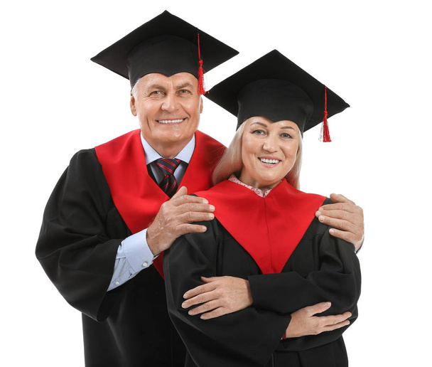 Mature couple in bachelor robes on white background - Photo, image