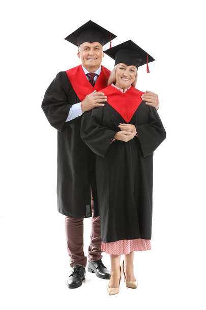 Mature couple in bachelor robes on white background - Foto, imagen