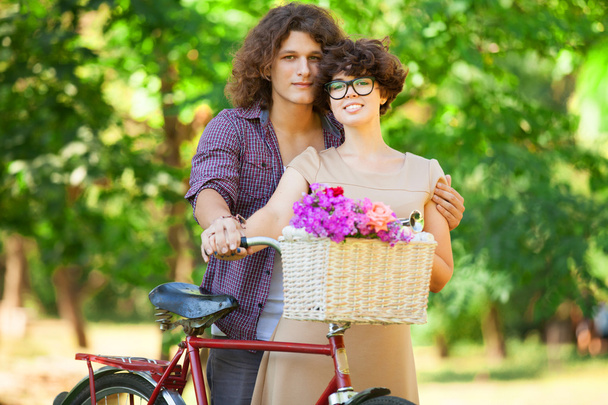 Couple with retro bike in the park - Photo, Image