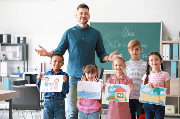 Cute children with teacher in classroom - Photo, Image