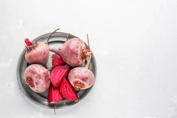 Plate with fresh beet on light background - Photo, image