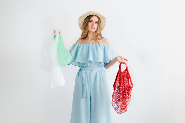 Girl compares a useful string bag and harmful plastic bags - Photo, Image