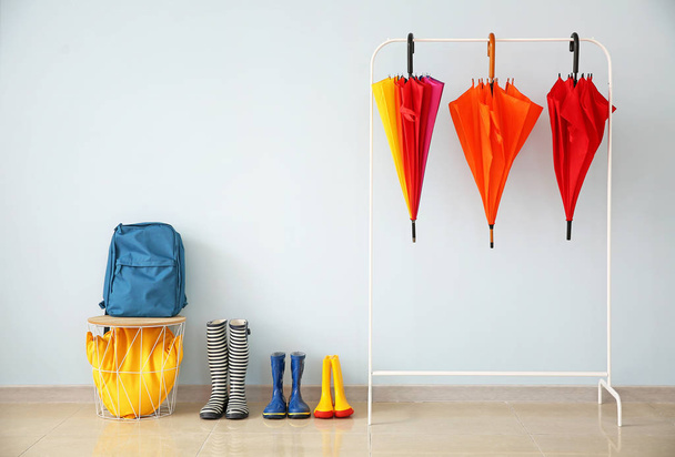 Stylish umbrellas with gumboots in hall - Photo, Image