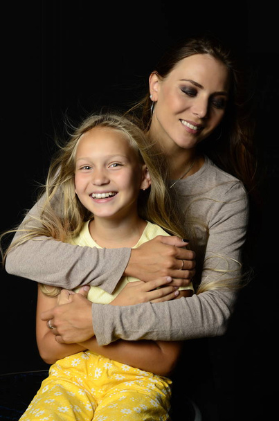 mother hugs her daughter - Foto, immagini
