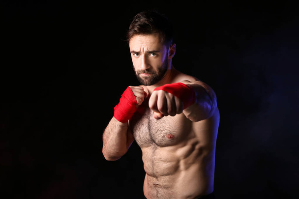 Strong male boxer on dark background - Fotoğraf, Görsel