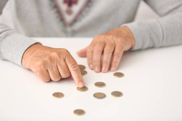 Femme âgée comptant les pièces sur la table, gros plan
 - Photo, image