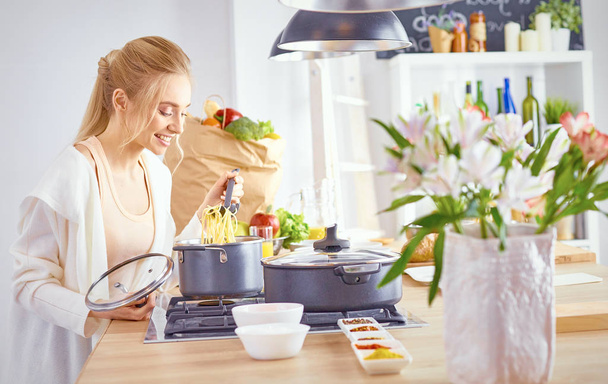 Young Woman Cooking in the kitchen. Healthy Food - Foto, Bild
