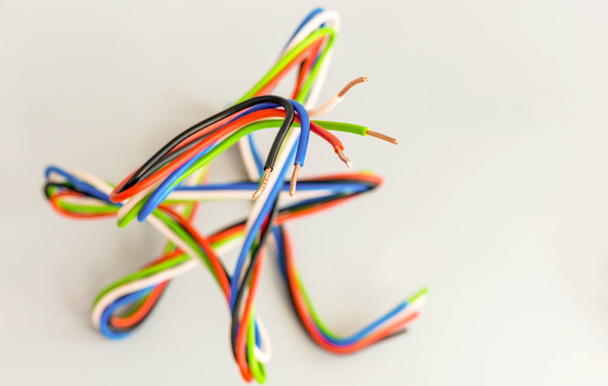 Przewody elektryczne o różnych kolorach w kształcie zakrzywionym na szarym grzbiecie - Zdjęcie, obraz
