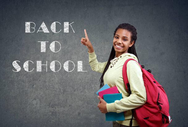 girl pointing on back to School sign - Foto, Imagen