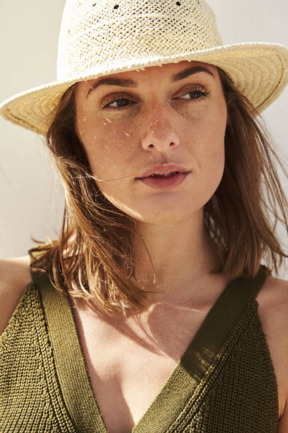 Thoughtful and beautiful woman looking away in sunhat - Фото, изображение