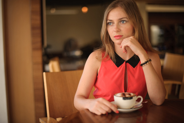 Pretty Young Woman in Cafe - 写真・画像