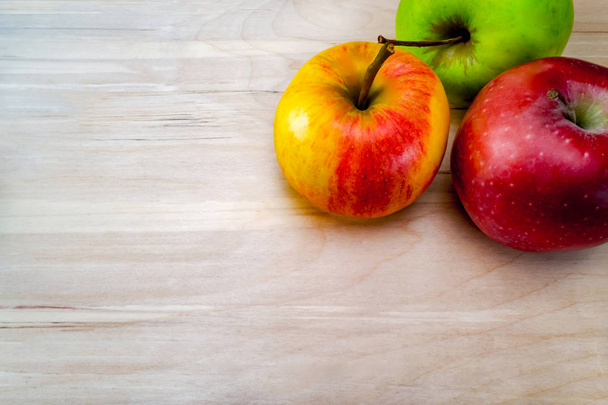 frische rote Äpfel, auf einem Holztisch, der Hintergrund ist ein Tisch aus heller Eiche. Freiraum für Text, Blick von oben - Foto, Bild
