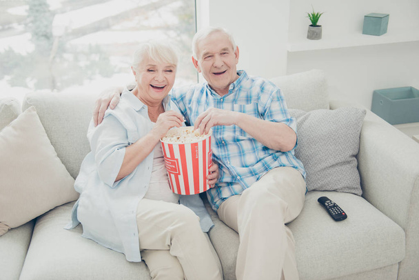 Above high angle view of two nice attractive cheerful cheery positive spouses having fun spending free time watching serial funny cinema in light white interior living-room indoors - Foto, immagini