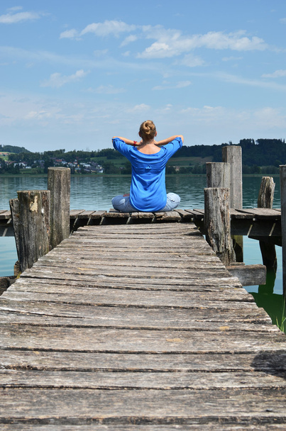 Girl on the wooden jetty. Switzerland - 写真・画像