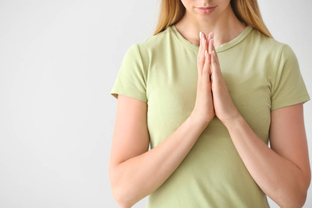 Religious young woman praying on white background - Valokuva, kuva