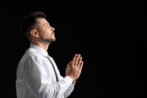 Religious man praying on dark background - Zdjęcie, obraz