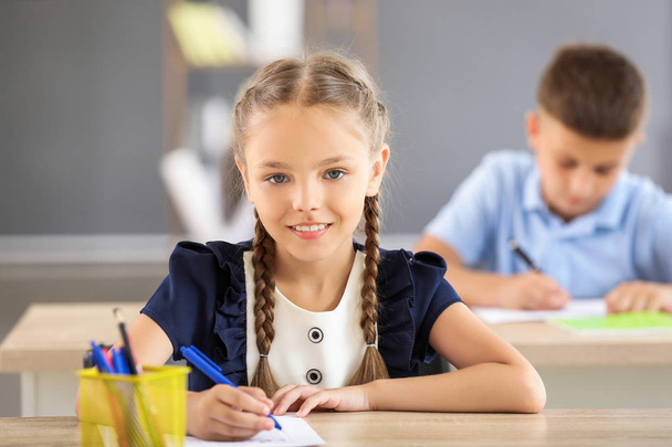Pupil passing school test in classroom - Фото, изображение