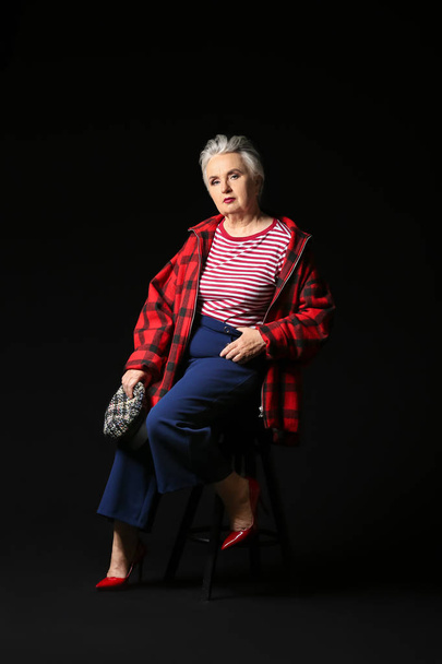 Stylish elderly woman on dark background - Fotó, kép