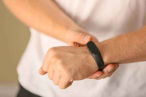 Man with fitness tracker checking his pulse, closeup - Photo, Image