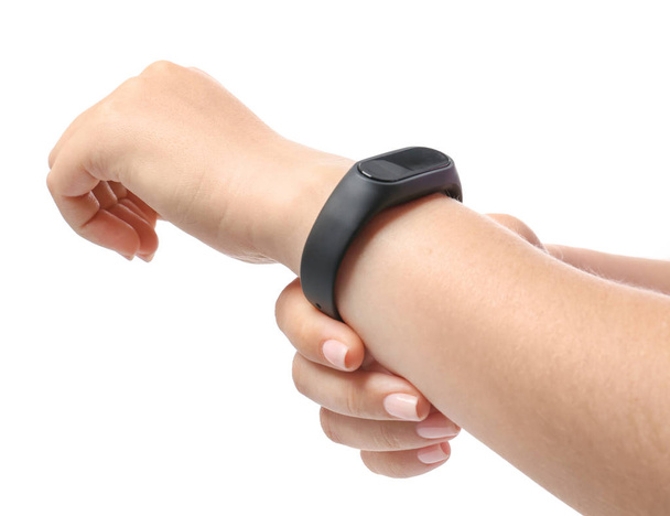 Woman with fitness band checking her pulse on white background - Photo, Image
