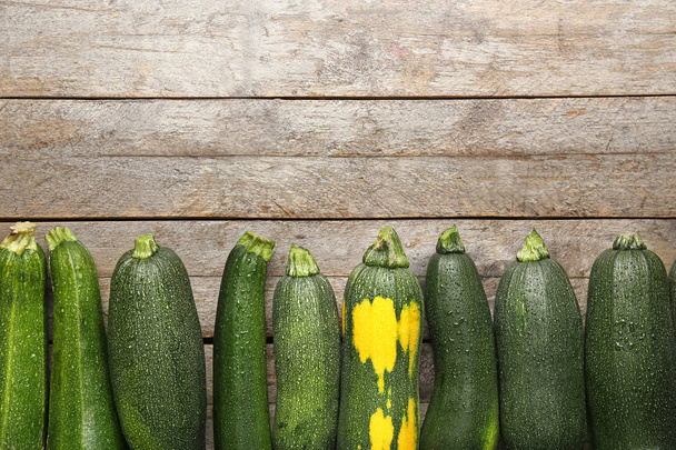 Fresh zucchini squashes on wooden background - Foto, afbeelding
