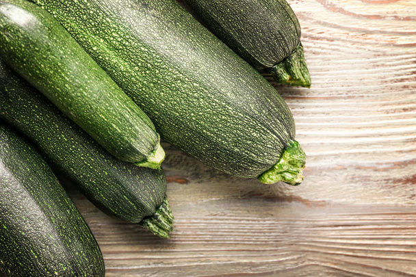 Fresh zucchini squashes on wooden background - Fotografie, Obrázek