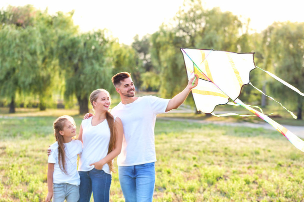Happy family flying kite outdoors - Фото, изображение