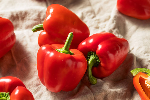 Raw Red Organic Bell Peppers - 写真・画像