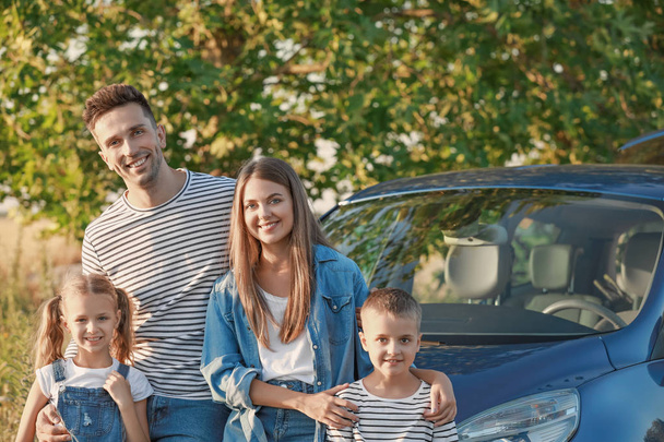 Familia feliz cerca de coche al aire libre - Foto, Imagen